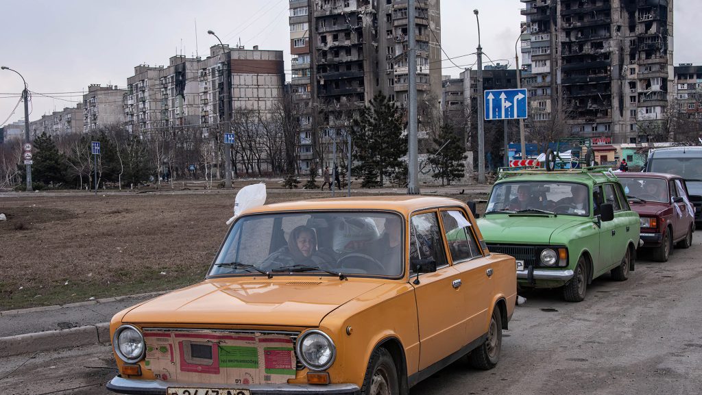 A long line of cars queue to leave the heavily damaged city of Mariupol following a recent lull on March 17.