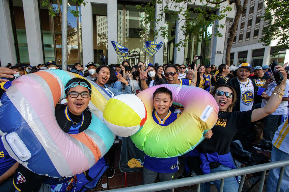 Пара фанатов наслаждается "политическая партия" Во время парада чемпионата Golden State Warriors на Маркет-стрит в Сан-Франциско, Калифорния, 20 июня 2022 года.